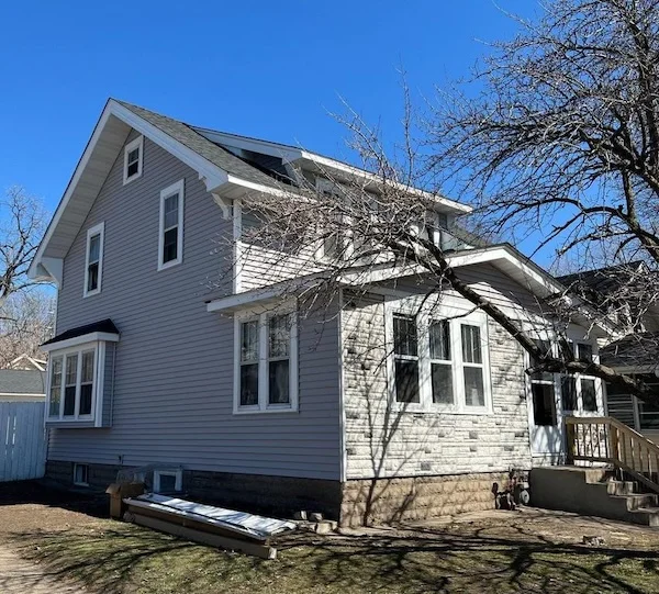 Gray vinyl siding installation project