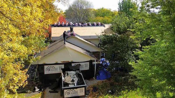 Residential Owens Corning asphalt shingle roof surrounded by autumn trees in Maple Grove, MN