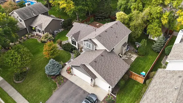Completed Owens Corning shingle roof replacement on a large residential home in Maple Grove, Minnesota