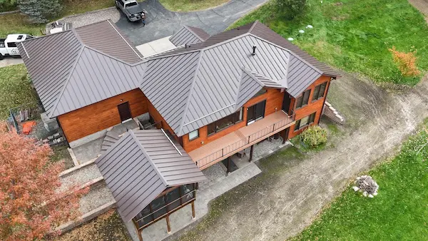 Aerial view of custom standing seam metal roofing with detailed rooflines and dormers in Aitkin, MN