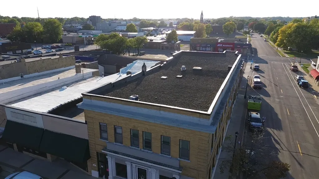commercial flat EPDM rubber roof replacement project for a downtown building